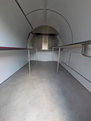 Plans de travail inox sur pieds et fond de la remorque, vue depuis l'entrée
